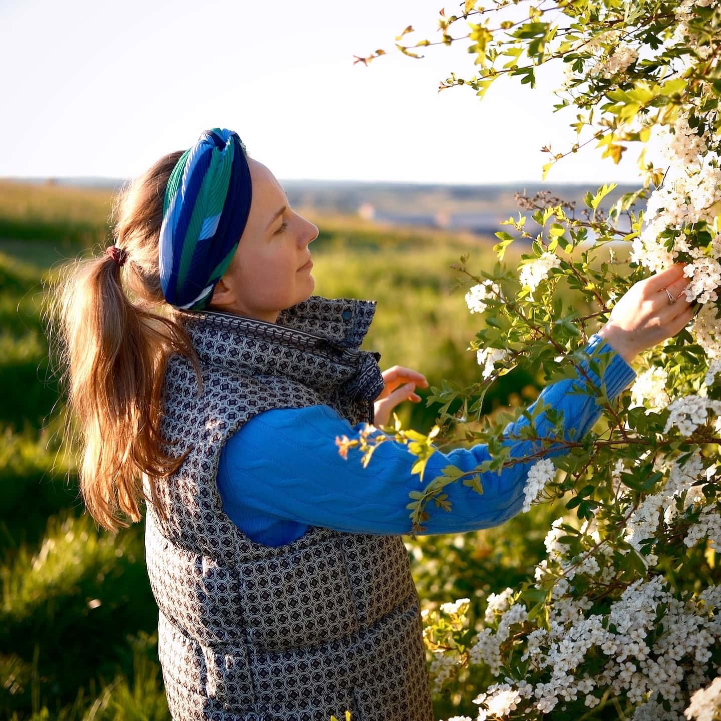 Photo of Joanna Formella in nature landscape with a meadow in the background.